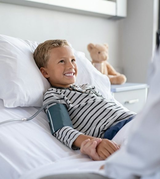 Cute boy lying on hospital bed